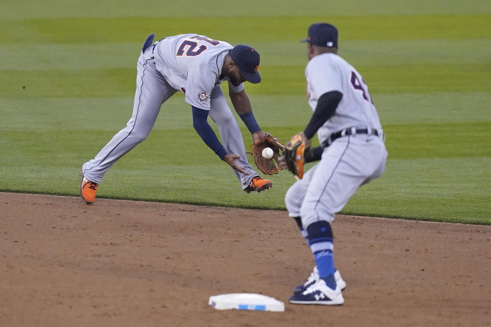 Detroit Tigers shortstop Willi Castro, left, makes a fielding error on a ground ball hit bt Oakland Athletics' Ramon Laureano during the third inning of a baseball game in Oakland, Calif., Thursday, April 15, 2021. At right is second baseman Jonathan Schoop. (AP Photo/Jeff Chiu)