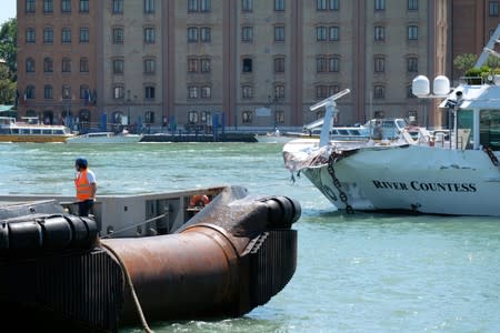 A boat is seen after a crash with MSC Opera at San Basilio dock in Venice