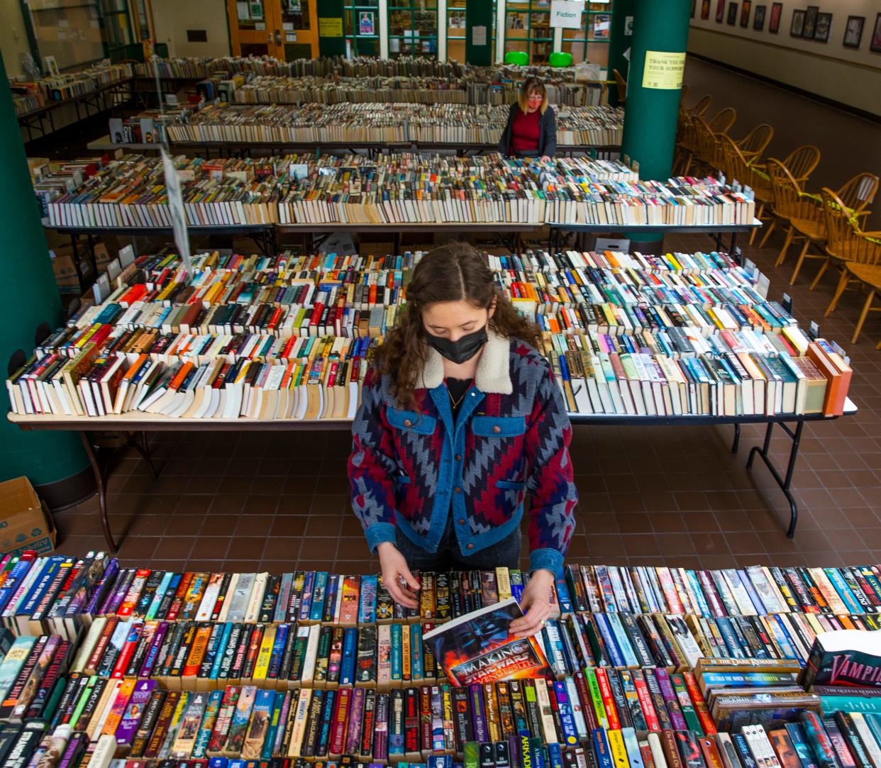 Springfield Public Library technician Riley Hicks organizes some of the hundreds of book available at the Friends of the Springfield Public Library 2022 book sale.