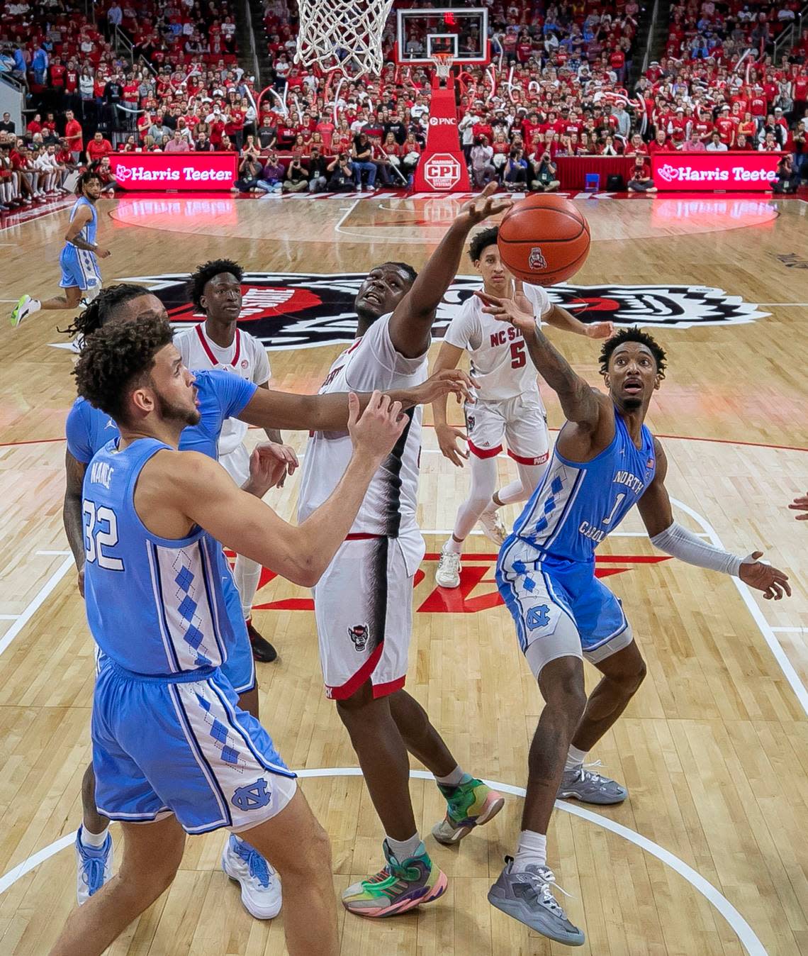 North Carolina’s Leaky Black (1) and N.C. State’s D.J. Burns (30) battle for a rebound in the second half on Sunday, February 19, 2023 at PNC Arena in Raleigh, N.C.