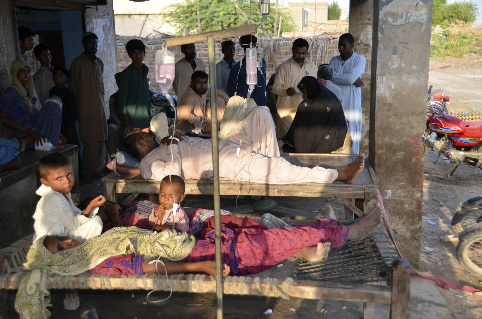 People receive treatment at a temporary medical center in Jaffarabad, a flood-hit district of Baluchistan province, Pakistan, Monday, Sept. 19, 2022. Pakistan said Monday there have been no fatalities for the past three days from the deadly floods that engulfed the country since mid-June, a hopeful sign that the nation is turning a corner on the disaster. (AP Photo/Zahid Hussain)