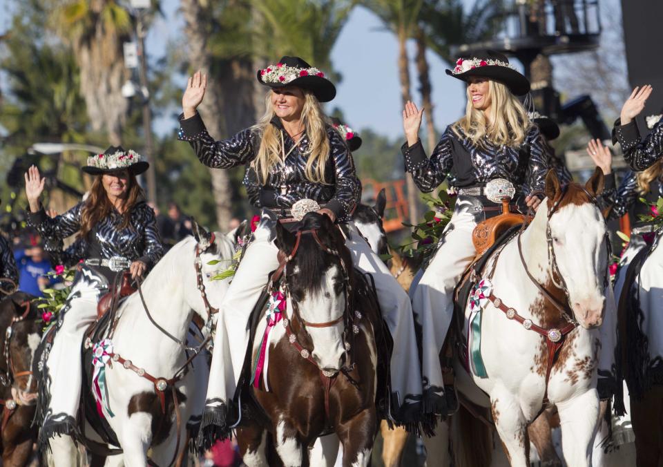The Norco Cowgirls Rodeo Drill Team ride their horses along Colorado Boulevard during the 125th Tournament of Roses Parade in Pasadena, Calif., Wednesday, Jan. 1, 2014. (AP Photo/Ringo H.W. Chiu)