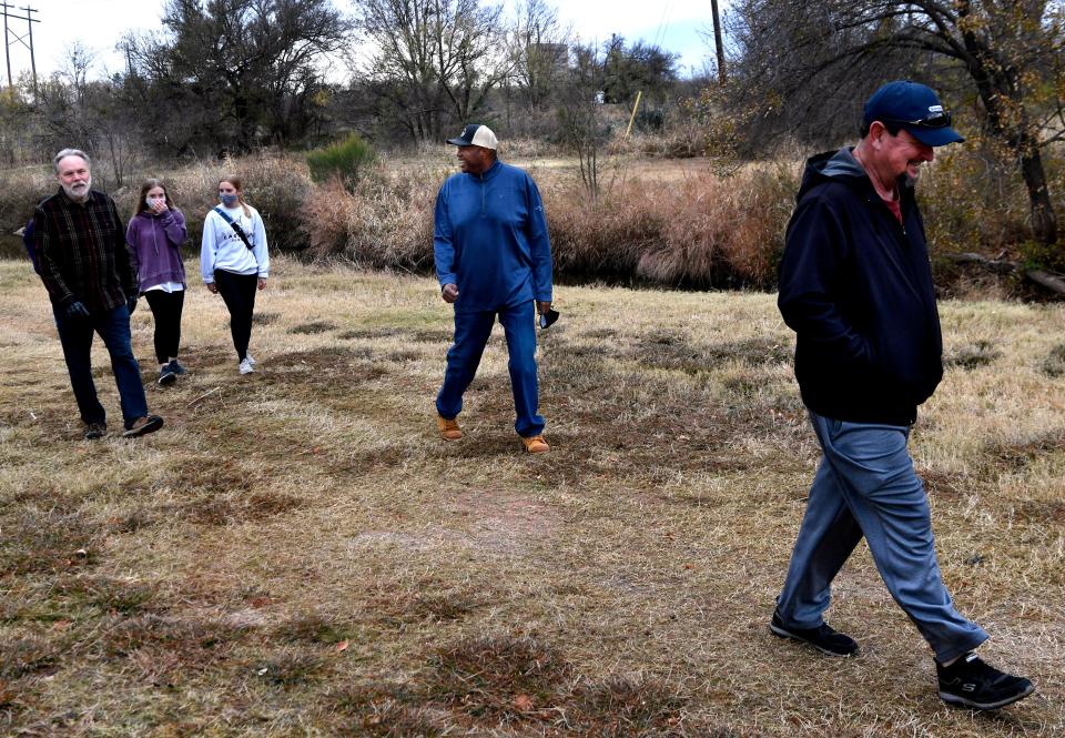 Mayor Anthony Williams (center) walks with a group of friends during Saturday's Mayor's Hike along Cedar Creek Waterway Dec. 5, 2020. 