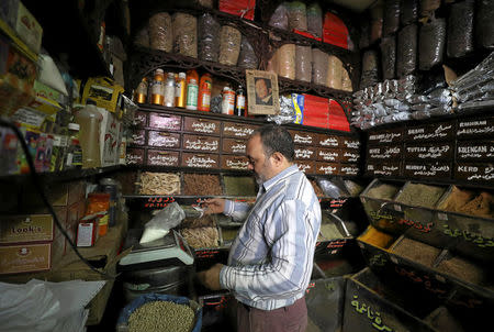 A worker at herbal store, takes ingredients to prepare natural herbal drug in Cairo, Egypt January 10, 2017. REUTERS/Mohamed Abd El Ghany