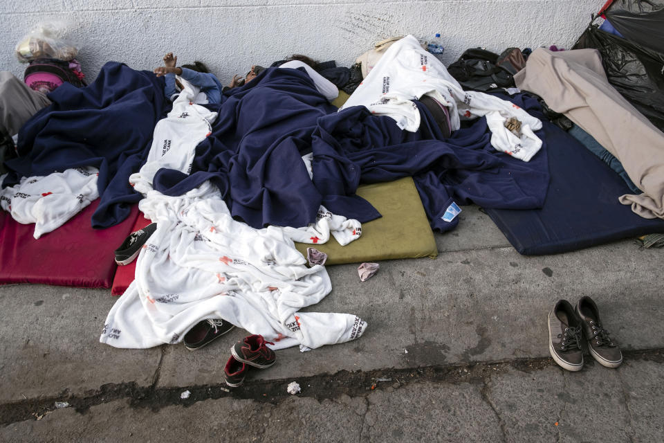 Image: Asylum seekers sleep on the street near the Paso del Norte border crossing bridge (Guillermo Arias / ACLU file)