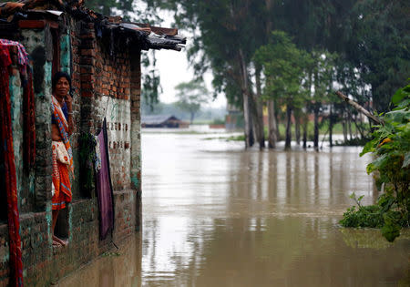 A woman looks out from her house at a flood affected area in Janakpur, Nepal August 13, 2017. REUTERS/Navesh Chitrakar