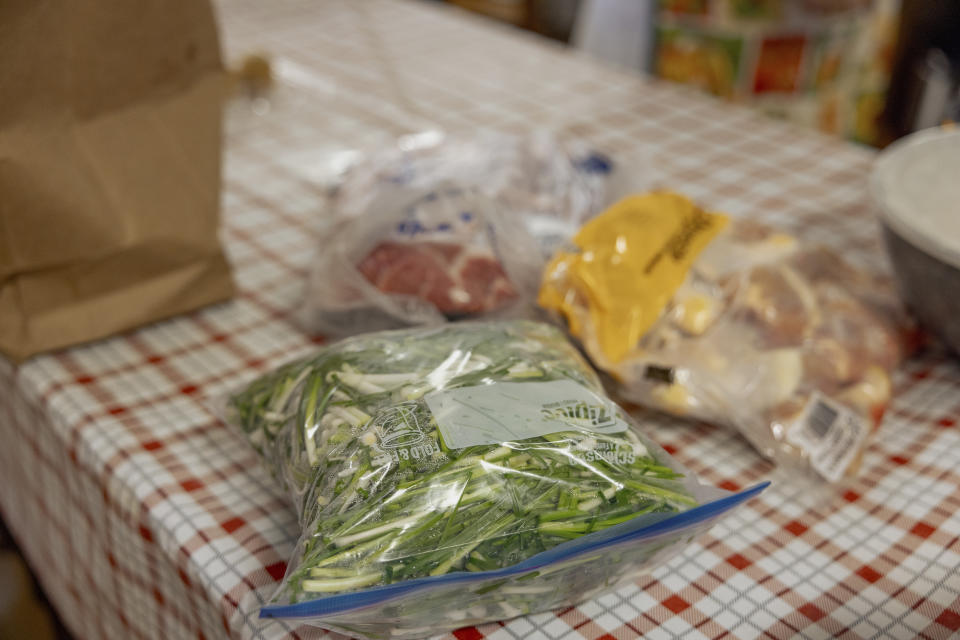 A bag of cleaned and chopped wild onions sits on the counter in the kitchen of the Springfield United Methodist Church in Okemah, Okla., April 5, 2024. Wild onion dinners are a common annual tradition among several Native American communities in Oklahoma. (AP Photo/Brittany Bendabout)