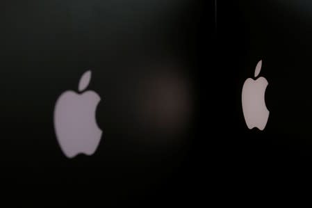 FILE PHOTO: Apple company logos are seen as two MacBooks stand next to each other in an office in Vienna