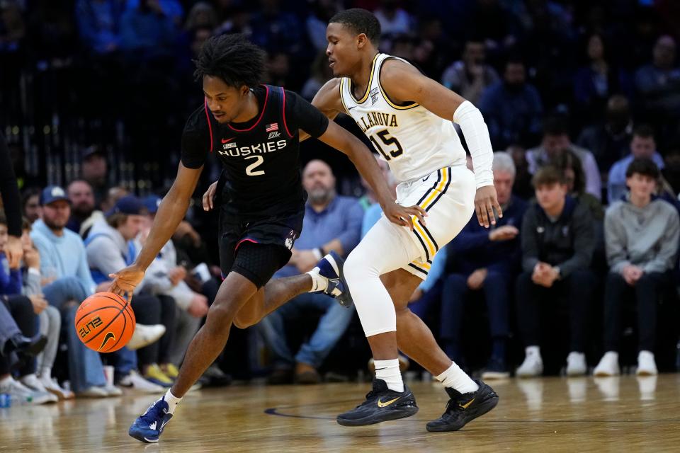 UConn's Tristen Newton, left, gets past Villanova's Jordan Longino during the second half of an NCAA college basketball game, Saturday, March 4, 2023, in Philadelphia. (AP Photo/Matt Slocum)