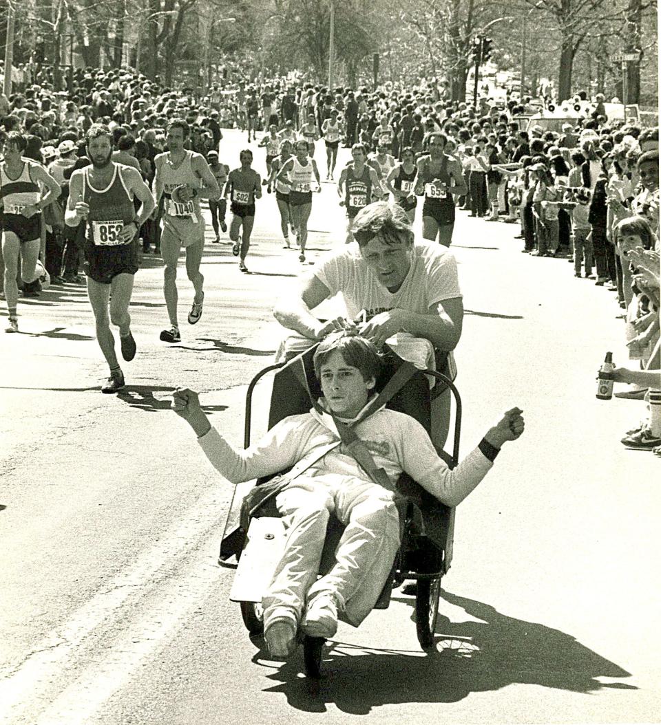 Dick and Ricky Hoyt heading up Heartbreak Hill in Newton in 1981.