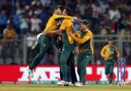 Cricket - South Africa v England - World Twenty20 cricket tournament - Mumbai, India, 18/03/2016. South Africa's Kyle Abbott (C) is congratulated by his teammates after taking the wicket of England's Jason Roy. REUTERS/Danish Siddiqui