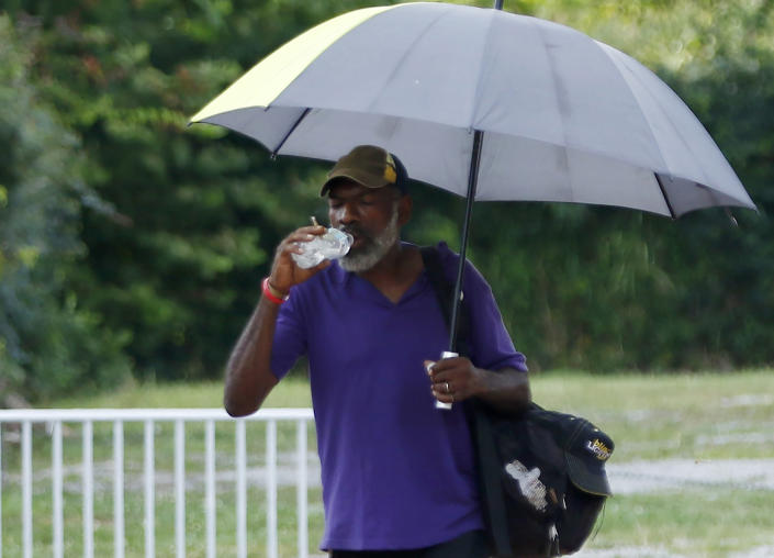 For Gregory Jones of Jackson, Miss., any walk in this "heat and sun means using my umbrella for shade," he said Tuesday, Aug. 13, 2019, as he hydratred while walking home in the Farish Street historical district. "My umbrella is not just for the rain." Weather forecasters warned of heat advisories climbing past 100 degrees in much of the South, from Texas to parts of South Carolina. (AP Photo/Rogelio V. Solis)