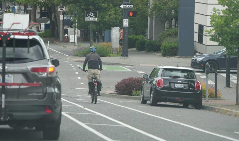 A cyclist bikes down the newly installed bike lane on Holly Street in downtown Bellingham, Wash.