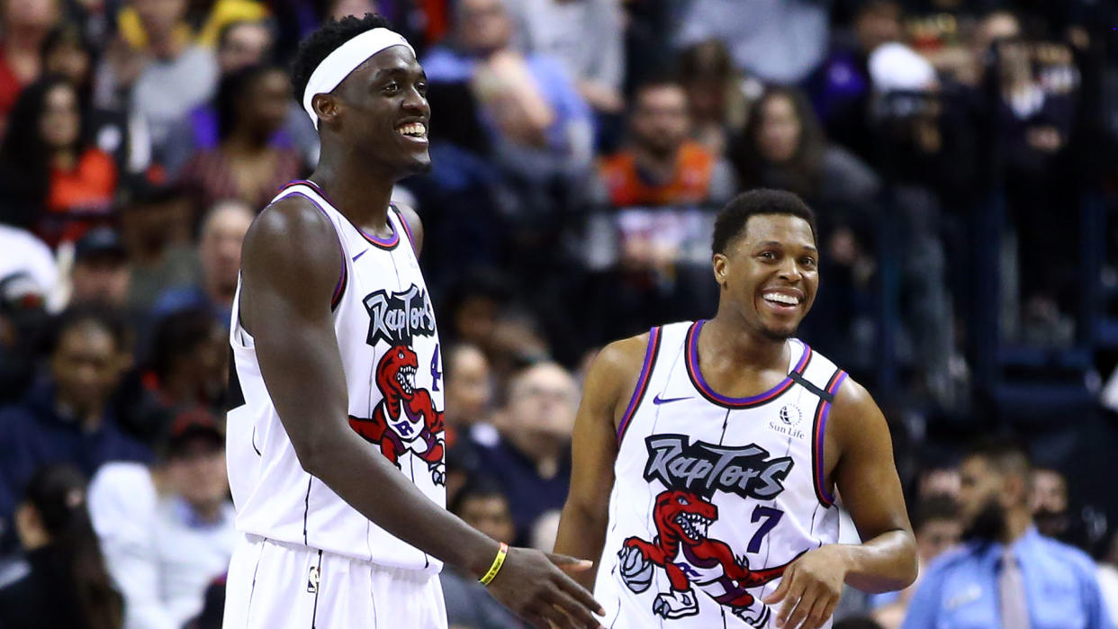 Pascal Siakam #43 and Kyle Lowry #7 of the Toronto Raptors share a laugh during a break in play.  (Photo by Vaughn Ridley/Getty Images)