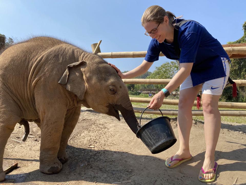 Katie Donegan feeding an elephant in Chiang Mai, Thailand. (Supplied)