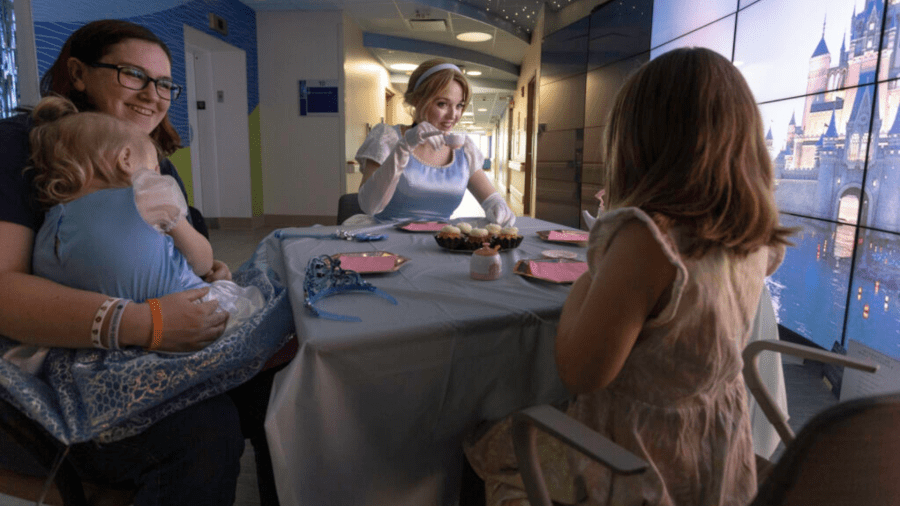 Pinkies up! Cinderella raises her tea with Aria, her mom, and Caroline. (HSHS St. Vincent Children's Hospital)
