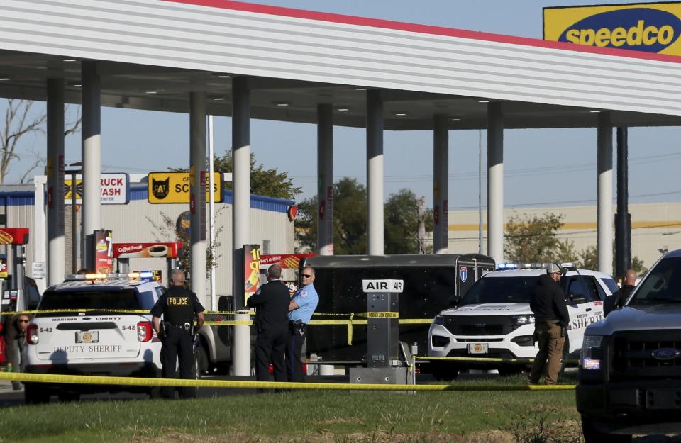ADDS THAT POLICE OFFICER HAS DIED - Police investigate the scene of a shooting on Tuesday, Oct. 26, 2021, at the Speedway gas station in Pontoon Beach., Ill. A police officer died Tuesday after being shot by a man at gas station in an Illinois suburb of St. Louis, authorities said. (Christian Gooden/St. Louis Post-Dispatch via AP)