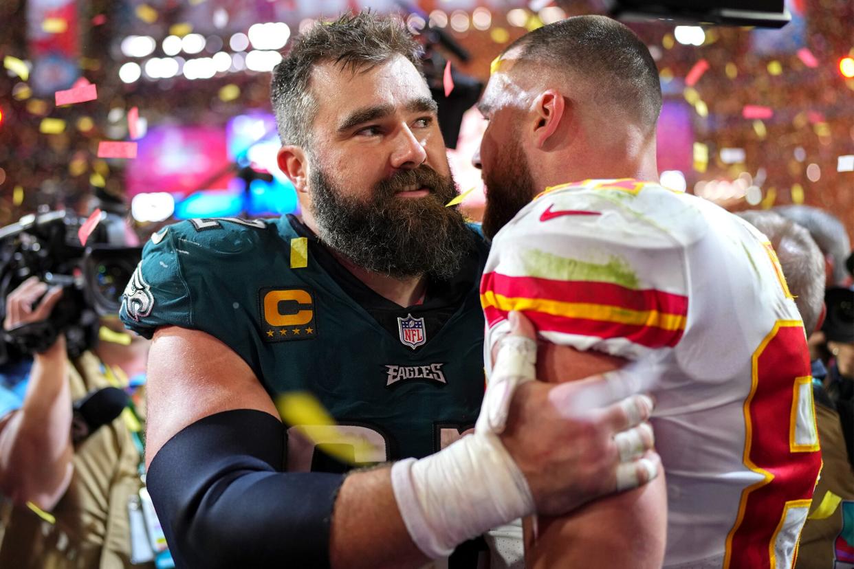 Jason Kelce #62 of the Philadelphia Eagles speaks with Travis Kelce #87 of the Kansas City Chiefs after Super Bowl LVII at State Farm Stadium on February 12, 2023 in Glendale, Arizona. The Chiefs defeated the Eagles 38-35