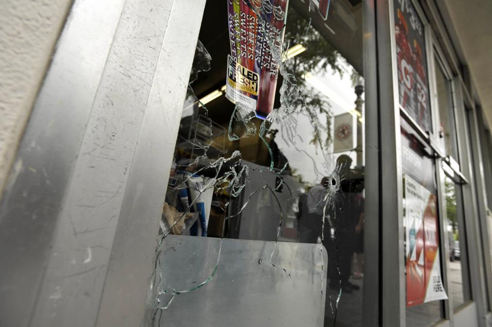 A window with bullet holes is pictured at the I.V. Deli Mart after a drive-by shooter went on a night time rampage in Isla Vista