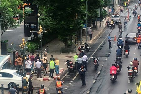 A crowd gathers near the site where explosions were heard in Bangkok