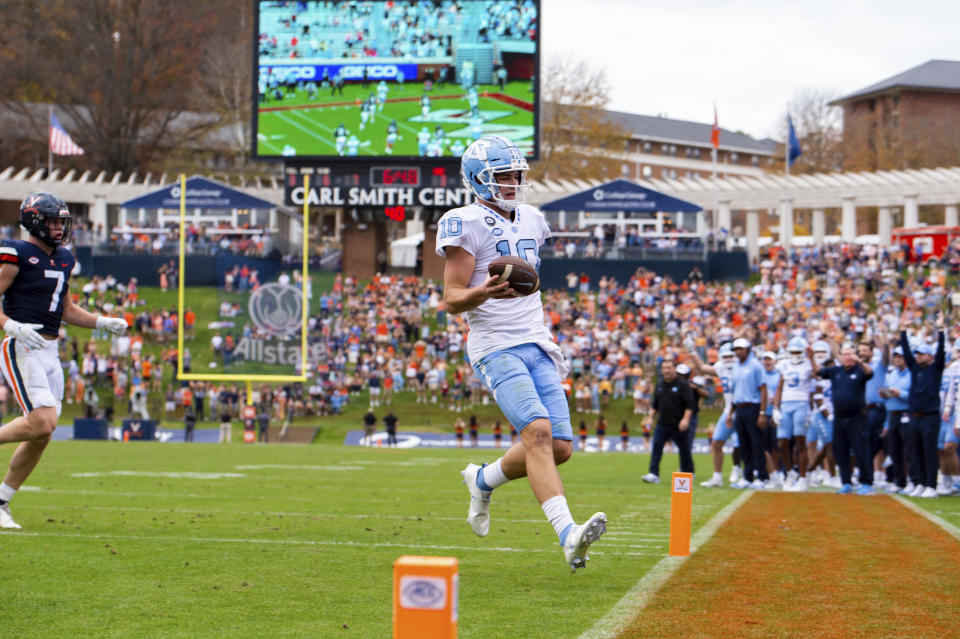 North Carolina quarterback Drake Maye (10) steps into the end zone for a touchdown during the first half of an NCAA college football game against Virginia on Saturday, Nov. 5, 2022, in Charlottesville, Va. (AP Photo/Mike Caudill)