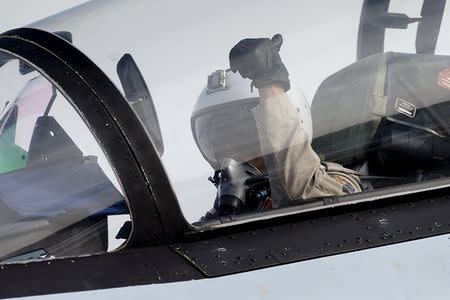 A pilot of a Sukhoi Su-30 fighter jet gestures before taking off at the Hmeymim air base near Latakia, Syria, in this handout photograph released by Russia's Defence Ministry October 22, 2015. REUTERS/Ministry of Defence of the Russian Federation/Handout via Reuters