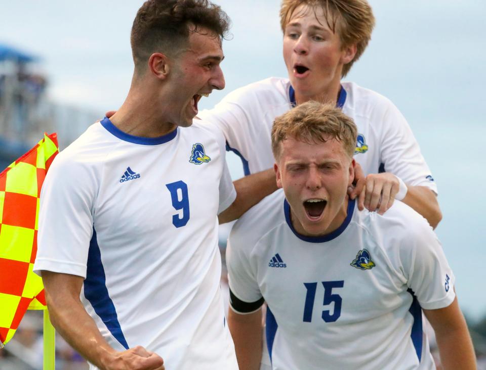 Delaware's Carlos Fernandez (9), Richard Monath (top) and Sam Donnellan celebrate Carlos Fernandez's goal in the first half of the Blue Hens' 3-2 win at Grant Stadium in Newark, Delaware, Thursday, August 24, 2023.
