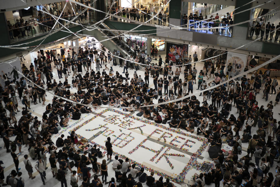 Residents gather at a shopping mall in Sha Tin to protest a teenage demonstrator shot at close range in the chest by a police officer and condemn police tactics and demand accountability, in Hong Kong, Wednesday, Oct. 2, 2019. The shooting Tuesday during widespread anti-government demonstrations on China's National Day was a fearsome escalation in Hong Kong's protest violence. The 18-year-old is the first known victim of police gunfire since the protests began in June. He was hospitalized and his condition was described by the government as stable on Wednesday. (AP Photo/Felipe Dana)