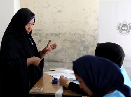 An Afghan woman arrives at a polling station to cast a vote in Kabul