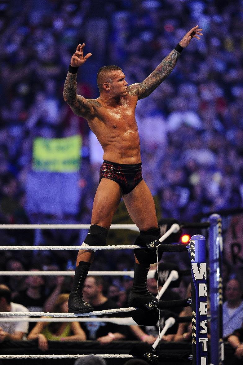 FILE- In this Sunday, April 3, 2011 file photo, WWE Superstar Randy Orton celebrates defeating CM Punk (not pictured) during WrestleMania XXVII at the Georgia Dome in Atlanta, Georgia on. World-famous WWE wrestlers such as John Cena, Shaemus and champion Randy Orton are in Saudi Arabia for three days of matches in the capital Riyadh. (Paul Abell/AP Images for WWE, File)