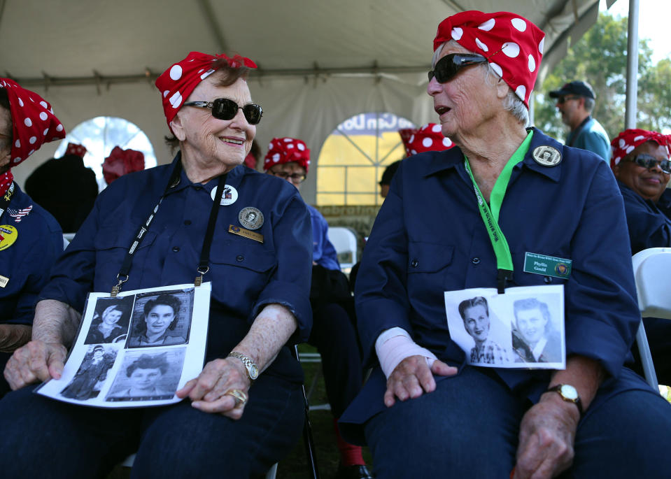 Agnes Moore, 95, and Phyllis Gould, 93, from left, who both worked as welders in the Richmond shipyards during WWII, chat as they wait to join with hundreds of women dressed as 