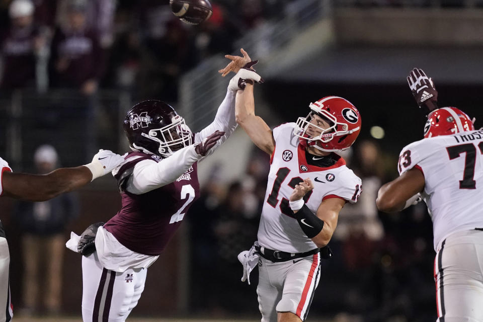 Mississippi State linebacker Tyrus Wheat (2) pressures Georgia quarterback Stetson Bennett (13) into throwing an interception during the first half of an NCAA college football game in Starkville, Miss., Saturday, Nov. 12, 2022. (AP Photo/Rogelio V. Solis)