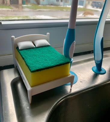 A humorous sponge holder in the shape of a bed where your sponge can drift away