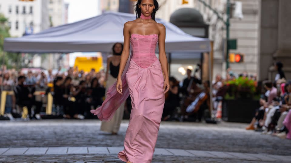 Pink appeared throughout the collection as a nod to Holi, from this draped look to a finale where models released pink powder in the wind. - David Dee Delgado/AFP/Getty Images