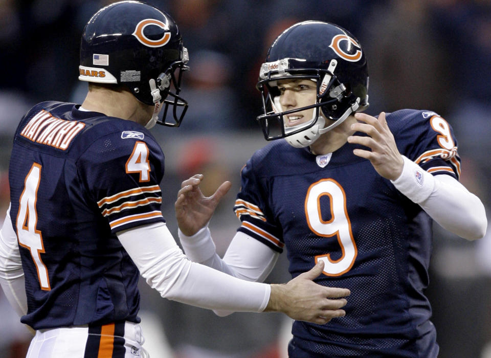 FILE - Chicago Bears place-kicker Robbie Gould, right, celebrates with his teammate punter Brad Maynard after kicking the game-winning field goal to defeat the Tampa Bay Buccaneers during overtime in an NFL football game in Chicago, Sunday, Dec.17, 2006. Gould, a Longtime NFL kicker, is retiring following an 18-year career that established himself as one of the game's best clutch kickers. (AP Photo/Nam Y. Huh, File)