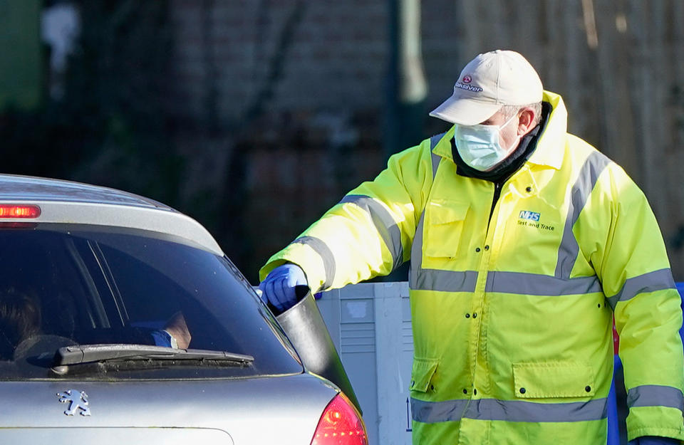 A member of NHS Test and Trace collects a sample from a member of the public at the drive-thru Covid-19 testing site on Hawkwood Road in Bournemouth. The UK Health Security Agency have said people in England without coronavirus symptoms who have a positive lateral flow test will no longer need a confirmatory PCR test from January 11. Picture date: Wednesday January 5, 2022. (Photo by Andrew Matthews/PA Images via Getty Images)