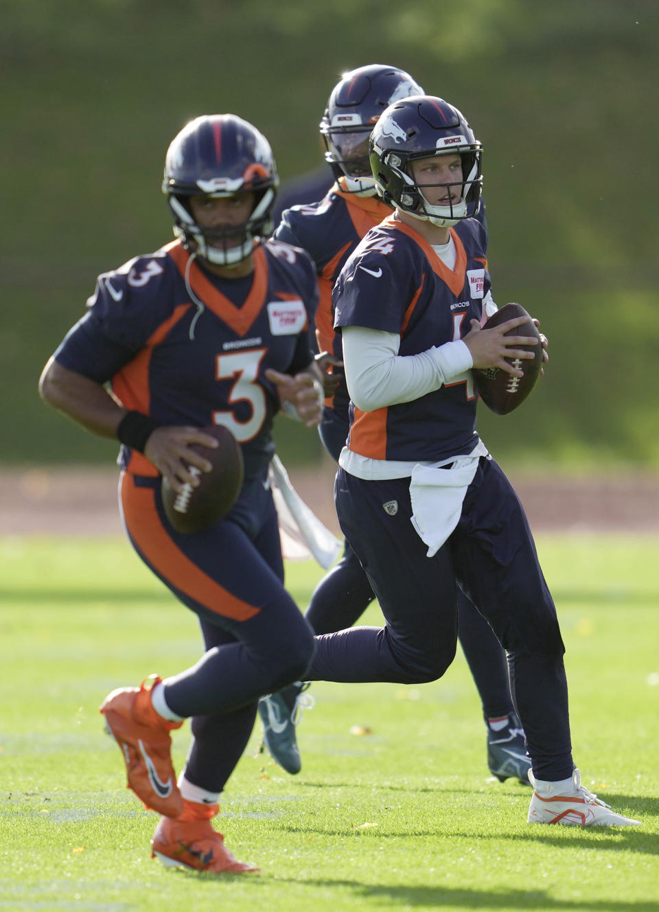 Denver Broncos quarterbacks, Russell Wilson, left, and Brett Rypien, attend a practice session in Harrow, England, Wednesday, Oct. 26, 2022 ahead the NFL game against Jacksonville Jaguars at the Wembley stadium on Sunday. (AP Photo/Kin Cheung)