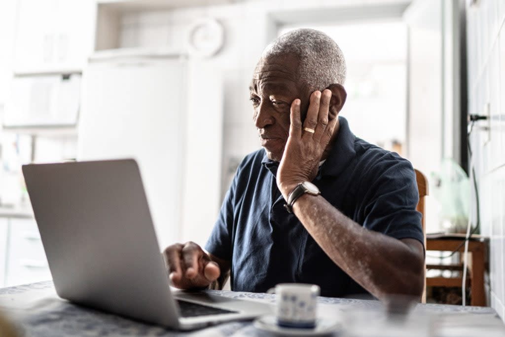 A man does work on his laptop. 