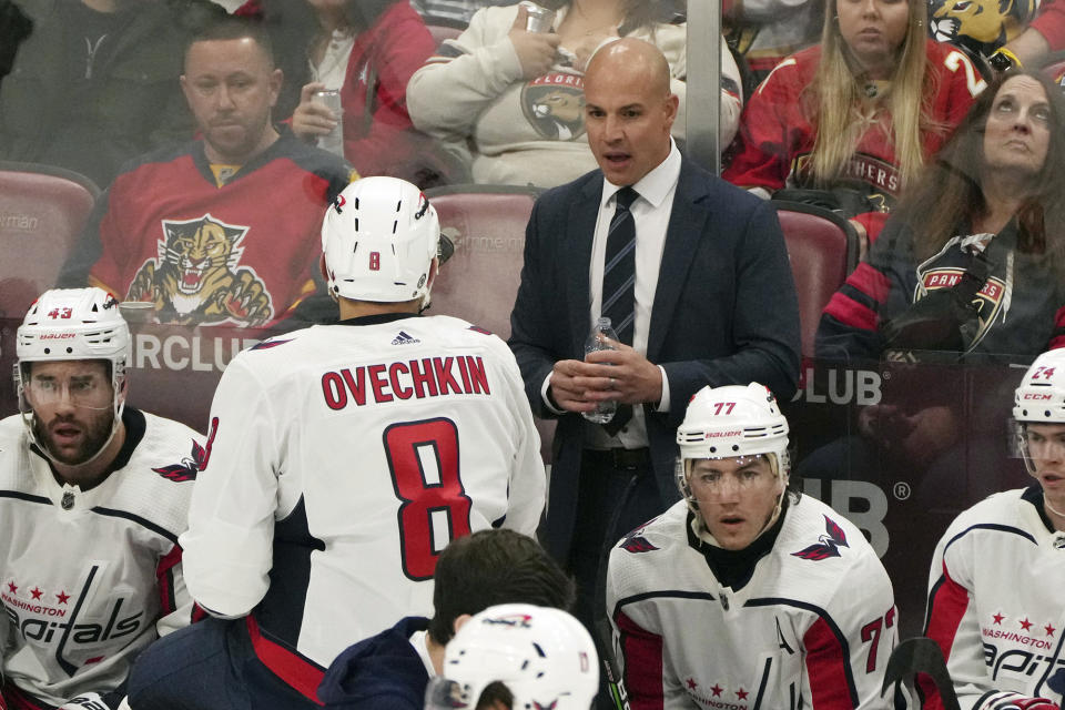 Washington Capitals head coach Spencer Carbery, upper center right, talks with left wing Alex Ovechkin (8) during the second period of an NHL hockey game against the Florida Panthers, Thursday, Feb. 8, 2024, in Sunrise, Fla. (AP Photo/Jim Rassol)