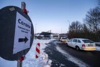 Cars queue in front of a Corona test station at the German-Czech Republic border in Furth im Wald, Germany, Monday, Jan. 25, 2021. German police say hundreds of cars and pedestrians are lining up at border crossings along the Czech-German border after Germany declared the Czech Republic a high risk area in the pandemic meaning it requires proof a negative coronavirus test results before entry. (Armin Weigel/dpa via AP)