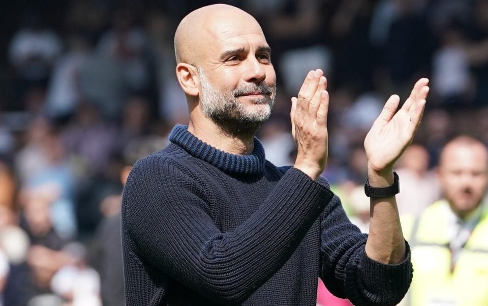 Pep Guardiola applauds the City fans at Fulham