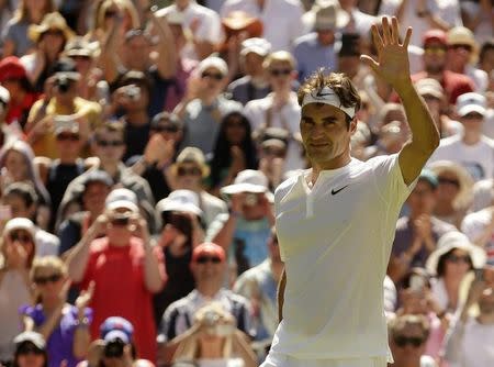 Roger Federer of Switzerland waves to fans after winning his match against Damir Dzumhur of Bosnia and Herzegovina at the Wimbledon Tennis Championships in London, June 30, 2015. REUTERS/Henry Browne