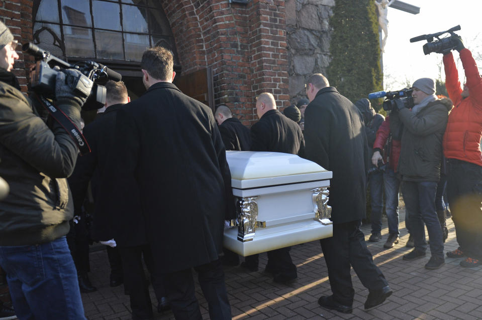 The coffin with the body of Lukasz Urban, the Polish truck driver killed in the Berlin Christmas market attack, is carried into the church in Banie, Poland, Friday, Dec. 30, 2016, ahead of the funeral ceremonies. (AP Photo/Lukasz Szelemej)
