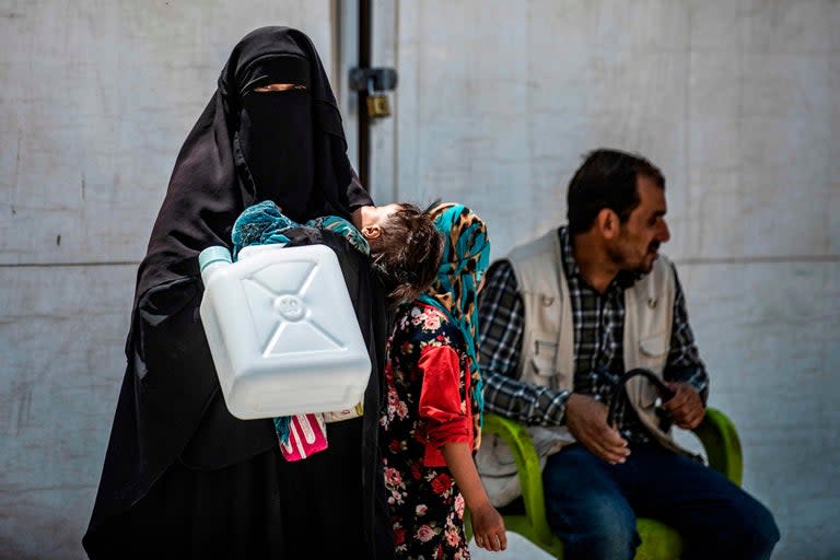 More than 11,000 foreign women and children related to Isis suspects are being held in “appalling” and “deadly conditions” in a locked desert camp in northeast Syria, a leading human rights organisation has warned.Human Rights Watch found overflowing latrines, sewage seeping into tattered tents, and inhabitants of al-Hol camp drinking wash water from tanks which contained worms.The organisation, which carried out several visits to the part of the camp which holds foreign women and children last month, urged countries to take back the thousands of foreign women and children being held by the Kurdish-led Autonomous Administration for northeast Syria in the camp.At least seven thousand of the children are under the age of 12, most of whom are survivors of heavy fighting and are highly vulnerable.Human Rights Watch witnessed young children with skin rashes, emaciated limbs, and swollen bellies sifting through mounds of stinking garbage in the blazing sun or lying limp on tent floors.The United Nations estimate at least 240 children have died en route or upon arrival to al-Hol. Aid groups and camp mangers said children are "regularly" dying from acute diarrhoea and flu-like infections, but warned the exact number may not be known as children are dying in tents rather than in hospitals and so may not be recorded.“Foreign women and children are indefinitely locked in a dustbowl inferno in northeast Syria while their home countries look the other way,” Letta Tayler, senior terrorism and counterterrorism researcher at Human Rights Watch, said. “Governments should be doing what they can to protect their citizens, not abandon them to disease and death in a foreign desert.”She added: “The conditions in al-Hol annex are untenable and unconscionable. Abandoning citizens to indefinite confinement without charge will only make the problem worse.”Human Rights Watch carried out interviews with 26 foreign women confined to an annex of the camp from countries including Canada, France, Australia, the Netherlands, Trinidad and Belgium. Guards from the Syrian Democratic Forces (SDF) at the camp are said to refuse to let the women and children leave unless they are escorted out for emergencies such as surgery which cannot be accessed in camp hospitals. Ayisha*, a mother-of-five from Trinidad, who is 37 weeks pregnant, said: “Please, tell me, where are my sons? Please, let me visit them”.She said the SDF took her two sons, ages 14 and 15, and their father when the family fled Isis-held Abu Badran in January.“First they said they would bring my boys to me in a month. Then they said two more weeks. Then they said they were sick in the hospital,” Aisha said of camp officials. “Then for the past two months, nothing.”Officials from the Autonomous Administration told Human Rights Watch they do not have plans to prosecute the women and children. When pressed about their legal status, they said when the women and children left Isis-held areas, they were “transferred to al-Hol to work on delivering them to their countries given that they are from different nationalities.” The Autonomous Administration has repeatedly called on home countries to take back all foreigners in their custody. Donor governments, the United Nations, and humanitarian agencies should immediately increase aid to all inhabitants at the camp, Human Rights Watch urged.None of the women researchers spoke to said they had been taken before a judge to review whether she should be detained. Nor did any say they had been contacted by a representative of their government.All but one of the foreign women who researchers spoke to said they wanted to return home. One woman from Uzbekistan explained she wanted to go to a third country due to worries of persecution if repatriated. The report comes amid warnings of growing radicalisation at the facility. Western governments have displayed a lack of willingness to take back their citizens from the camps due to concerns they constitute a security risk. The British government has refused to repatriate any of its citizens who went to join Isis - also citing security concerns. There are also legal questions around taking children from their parents.Human Rights Watch say conditions are “dire” throughout al-Hol which holds 62,000 Syrians and Iraqis in the main camp sections - most of whom are also wives and children of men accused of Isis membership. But the worst conditions are said to be in the annex holding the 11,000 non-Iraqi foreigners. Aid workers said the annex gets less aid from donors and its inhabitants must wait for armed escorts to bring them to the camp market, hospitals, and food distribution centre, which Syrian and Iraqi women and children can reach freely.More than 7,000 foreign children and 3,000 foreign women from about 50 countries are held in the al-Hol annex according to officials from the Autonomous Administration. Those children in al-Hol only constitute a fraction of a much larger group of children allegedly associated with armed conflict who are stranded in camps, detention centres and orphanages across Syria but particularly in the northeast. UNICEF estimates that in the northwest province of Idlib nearly one million children have been trapped for months on end amid heavy fighting. *Ayisha is not her names as she did not want her real names used