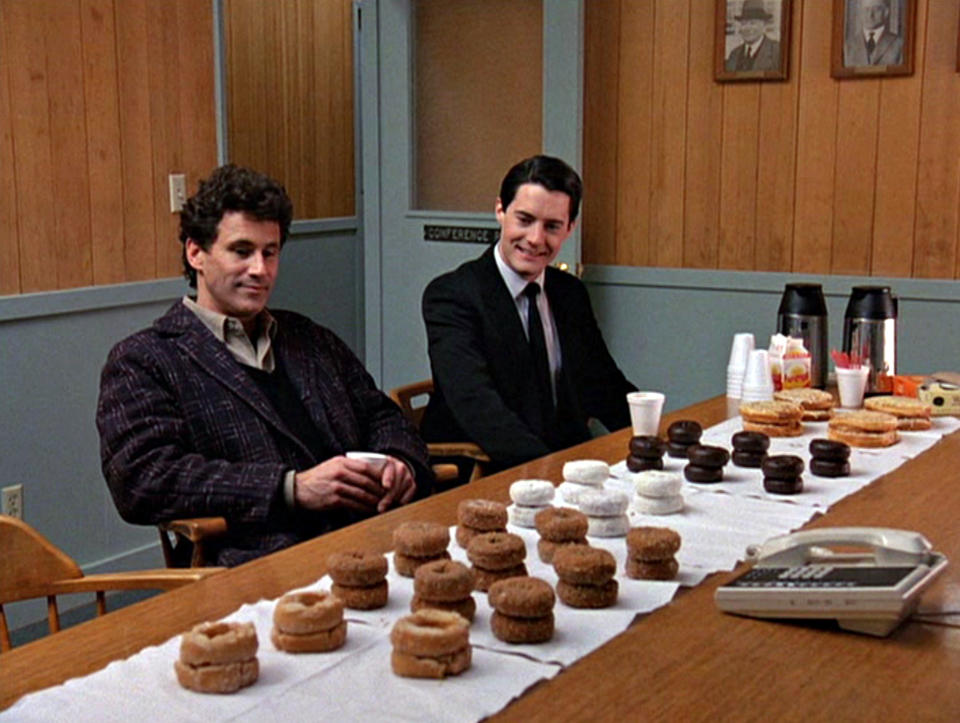 Michael Ontkean as Sheriff Harry S. Truman (left) and Kyle MacLachlan as Special Agent Dale Cooper eye donuts arrayed on a table in a scene from the pilot episode of 'Twin Peaks'. (Photo by CBS Photo Archive/Getty Images)