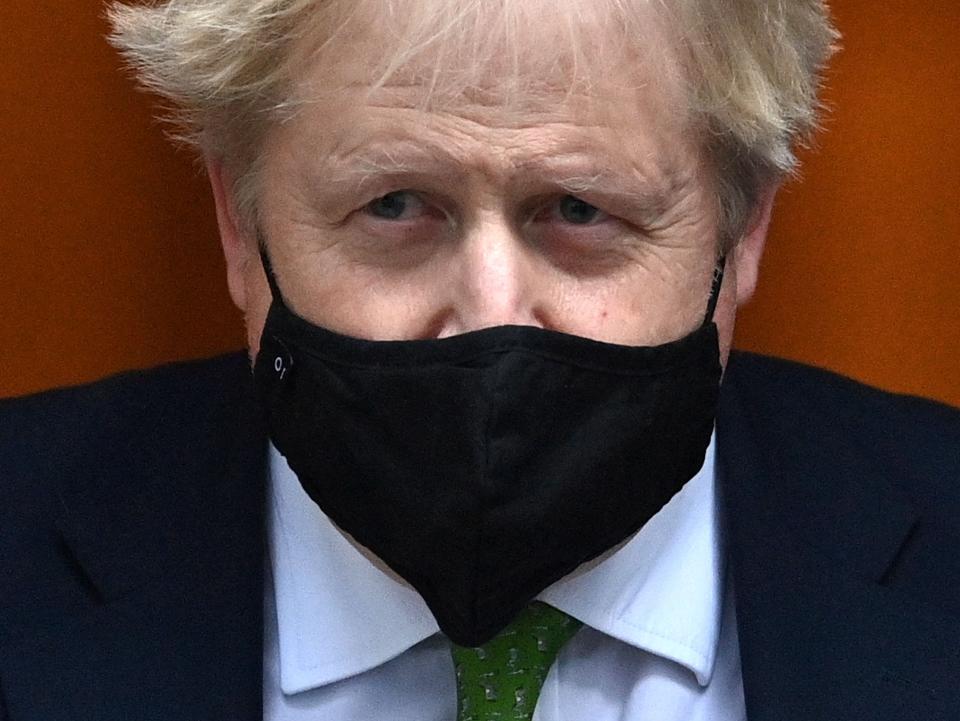 Boris Johnson leaves 10 Downing Street to attend PMQs where he made a statement on Covid (AFP via Getty Images)