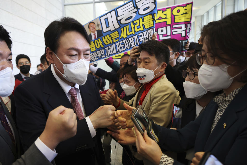 South Korea’s conservative former top prosecutor Yoon Suk Yeol, center, celebrates with his supporters after being chosen as presidential election candidate in Seoul, South Korea Friday, Nov. 5, 2021. Yoon won the main opposition People Power Party’s hotly contested nomination for next March’s presidential election on Friday. (Kim Hong-ji/Pool Photo via AP)