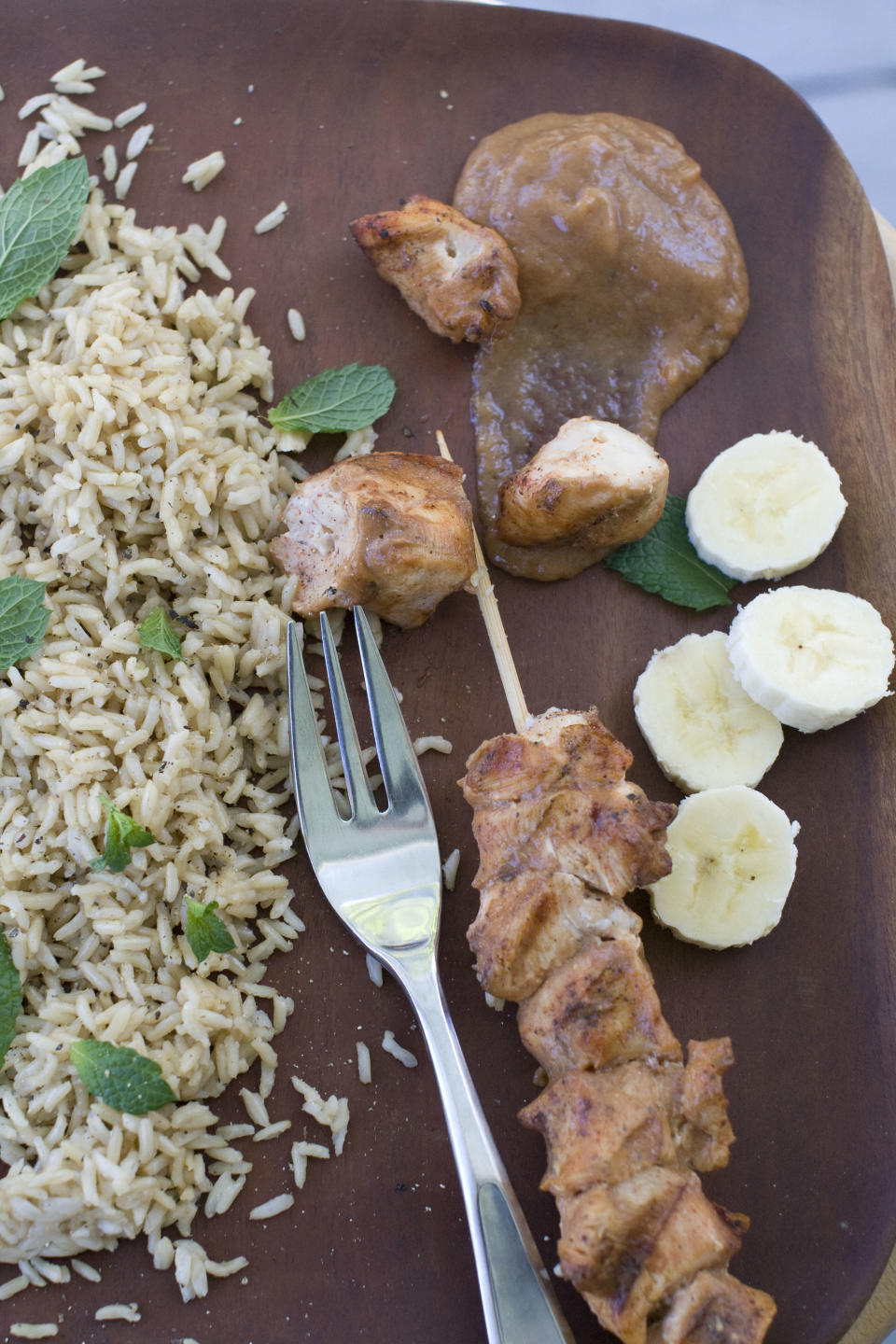 In this Aug. 5, 2013 photo, chicken kebabs with chili banana sauce are shown, in Concord, N.H. (AP Photo/Matthew Mead)