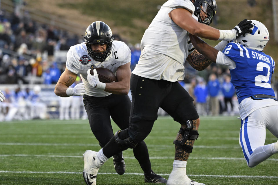 UCF running back Isaiah Bowser (5) runs the ball and scores a touchdown during the second half of the Military Bowl NCAA college football game against Duke, Wednesday, Dec. 28, 2022, in Annapolis, Md. (AP Photo/Terrance Williams)