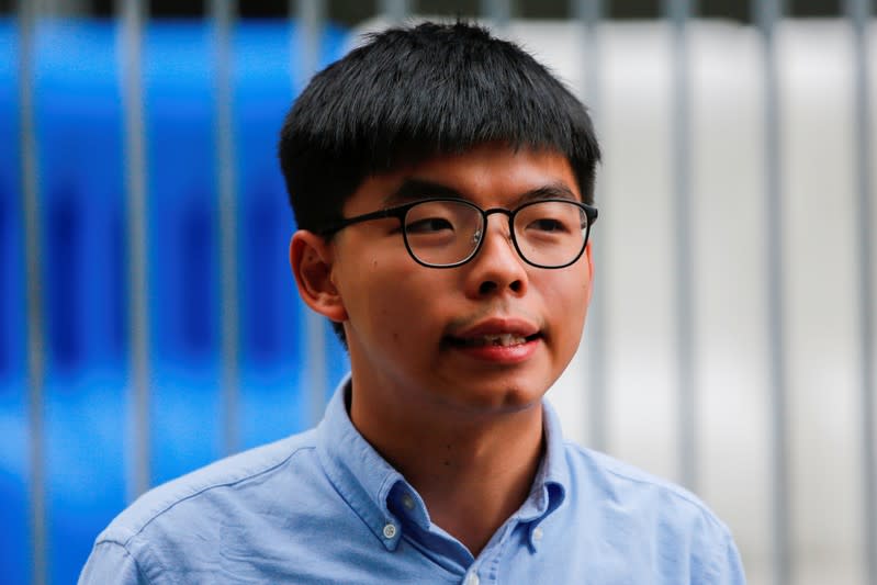 Pro-democracy activist Joshua Wong speaks to journalists after being disqualified from running in local district's council elections in November, in Hong Kong